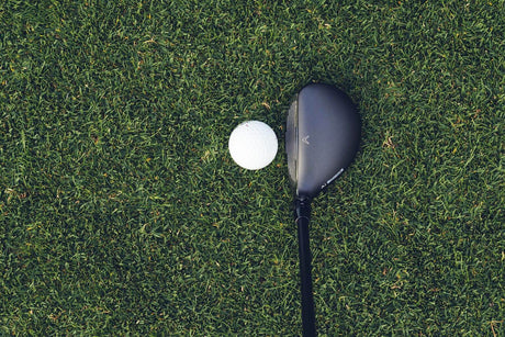 Hybrid at address beside the golf ball, showing its compact head shape, easy‑launch design, and confidence‑inspiring setup.