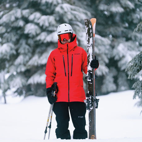 Close-up of a professional skier wearing high-performance, waterproof winter apparel designed for extreme snow sports.
