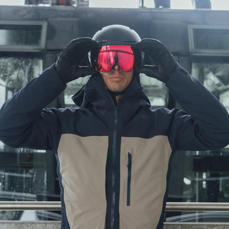 Close-up of essential ski and snowboard gear, featuring high-performance goggles and protective winter outerwear.