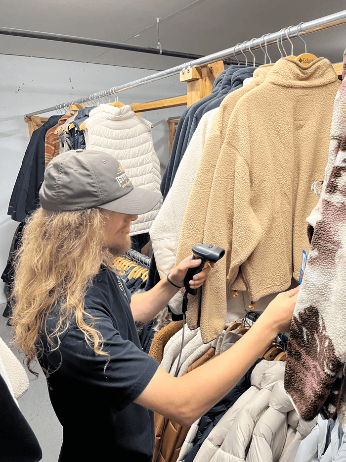 An Inventory Associate at Golfer's & Skier's Outlet scanning apparel stock and managing shipments in Oshkosh, Wisconsin.