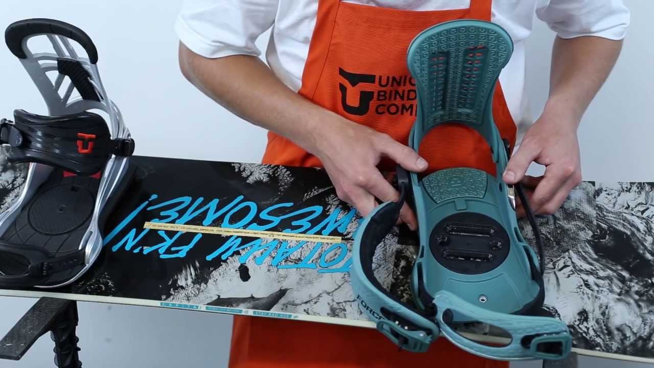A technician demonstrates a custom snowboard binding mount and stance setup for a Fox Valley winter sports video.